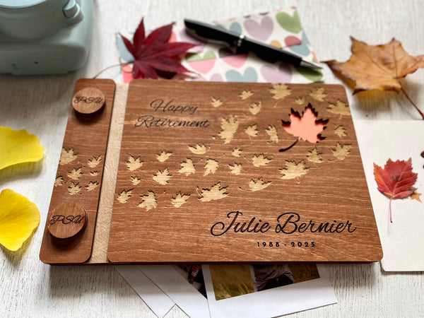 Personalized retirement guest book with brown stain wooden covers and engraved text and maple leaves motif