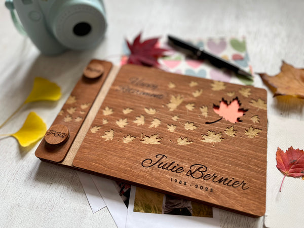 Personalized retirement guest book with brown stain wooden covers and engraved text and maple leaves motif