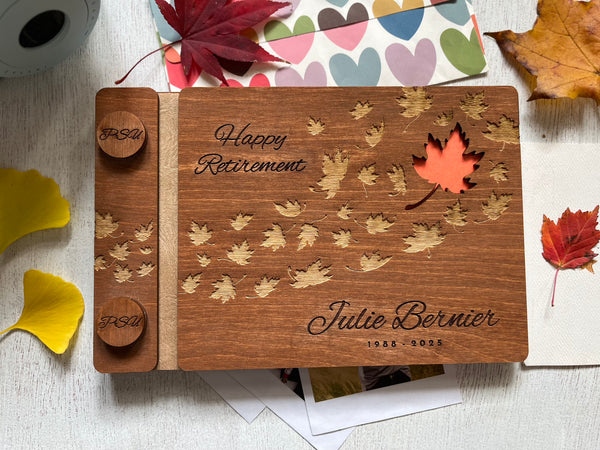 Personalized retirement guest book with brown stain wooden covers and engraved text and maple leaves motif