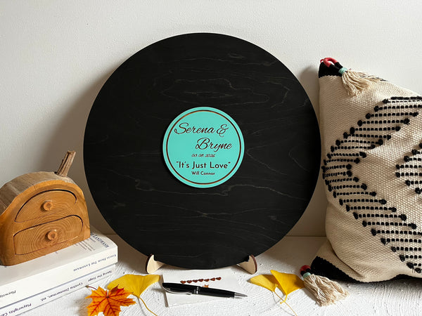 Round decorative round plaque made to look like vinyl record with engraved names on a stand