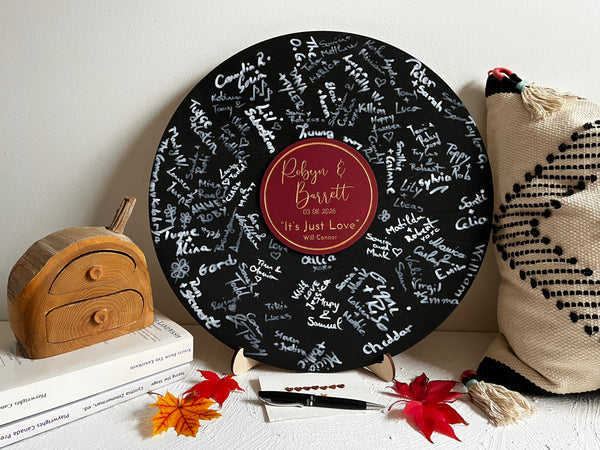 Decorative music record board with signatures and a personalized label with the name of the newlyweds and their favourite song and artist