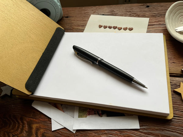 open quince guest book with pen
