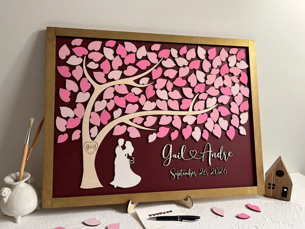 framed guest book with tree of life, pink ;eaves and gold frame with personalized name and wedding date