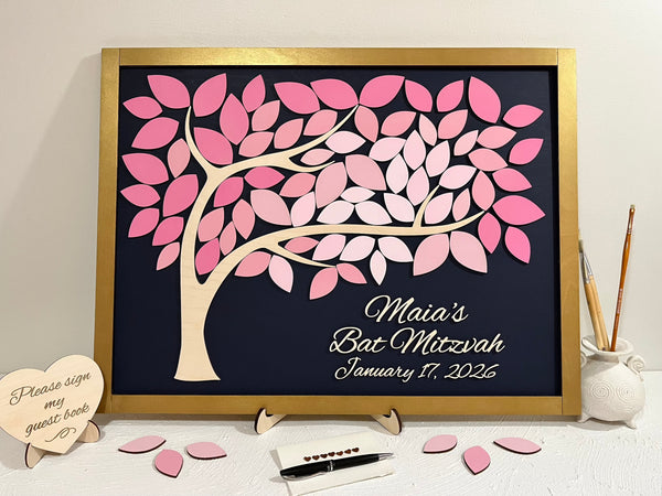 Decorative guest book with pink leaf design for a Bat Mitzvah event with gold frame