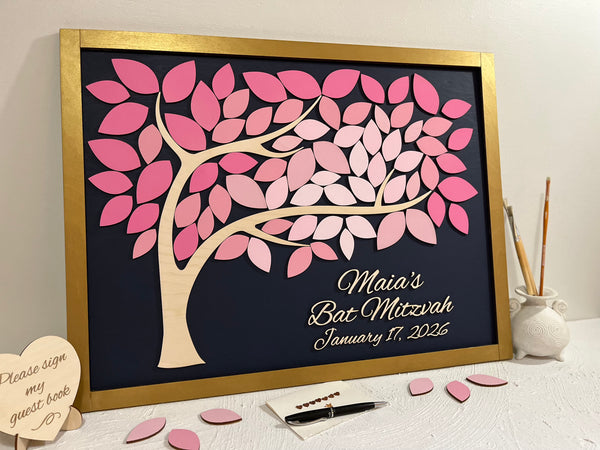 Decorative tree with pink leaves on a black background, framed in gold, for a Bat Mitzvah event.