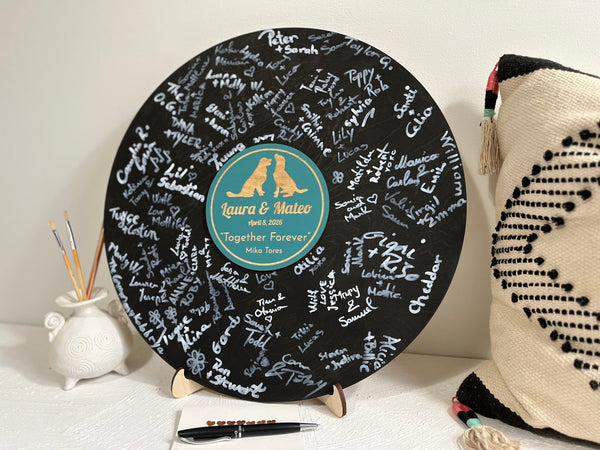 Personalized vinyl record with engraved names and a couple or golden retriever silhouettes- used as a wedding guest book alternative for guest signatures