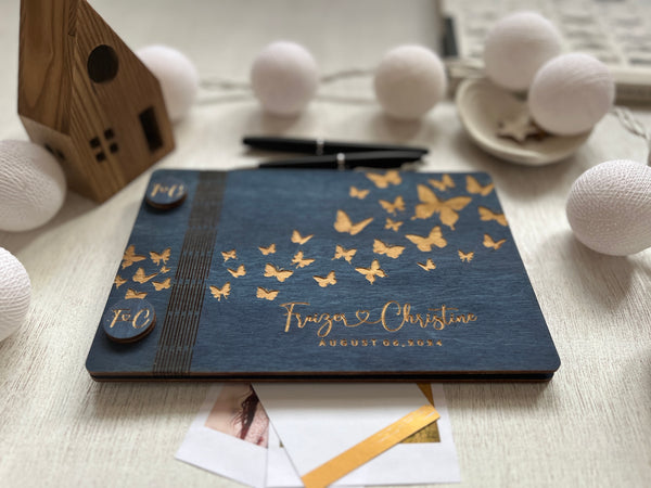 classic guest book with wood covers on navy stain wood