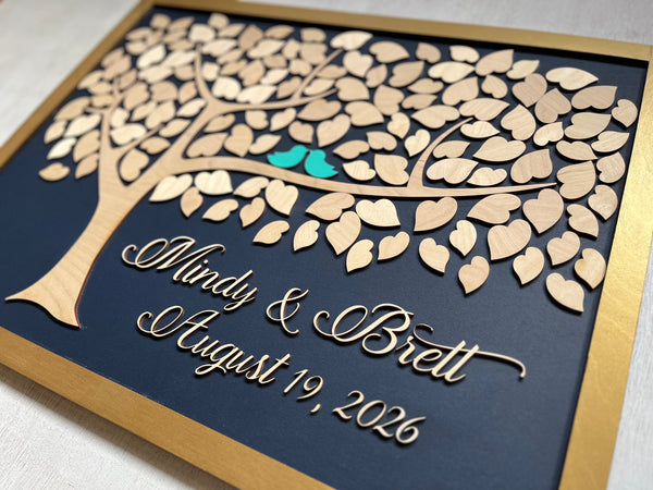Framed guest book with a tree design, two blue birds, and personalized text on a navy background.
