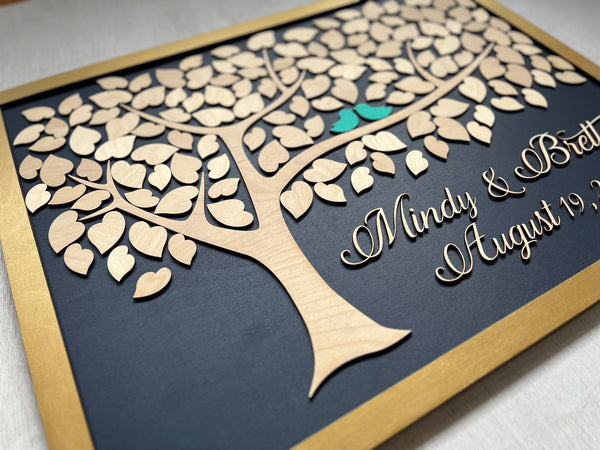 Framed guest book with a tree design, two blue birds, and personalized text on a navy background.