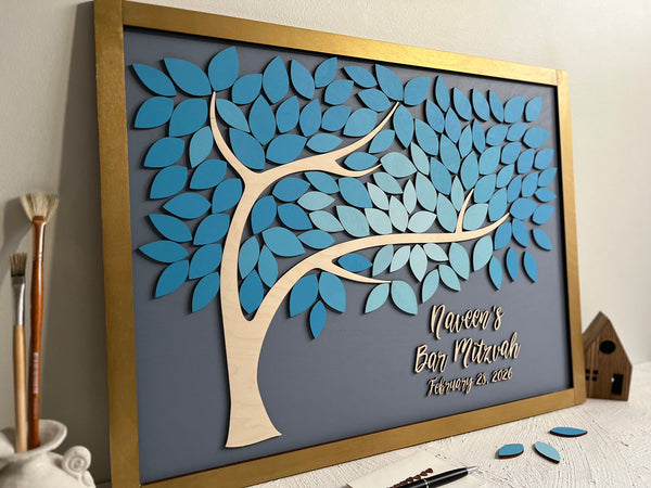 Decorative wall art with a tree design and personalized text on a gray background. The board is made with a tree and leaves for guests to sign- to be used at coming of age celebrations such as Bar or Bat Mitzvah, Sweet 16, Quince or even weddings.