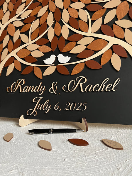 detail of magnetic guest book alternative with two trees and magnetic leaves for guests to sign