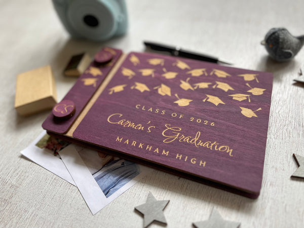 Graduation-themed album with caps design on a purple background, personalized with a name, school and Class of 2026