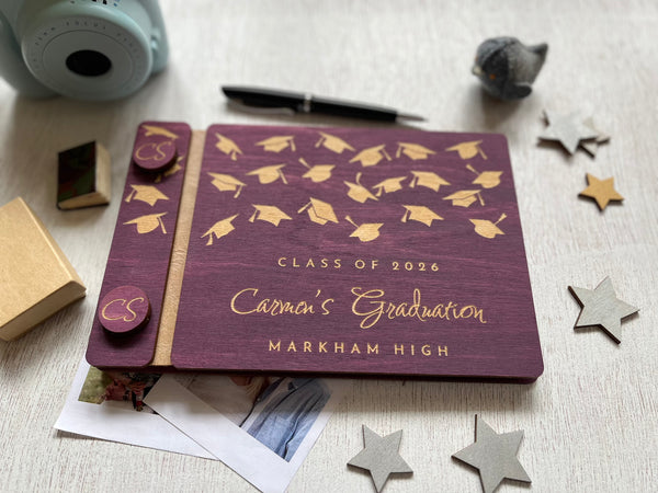 Graduation-themed guest book with caps design on a purple background, personalized with a name, school and Class of 2026