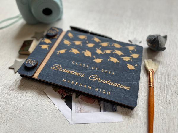 Graduation-themed notebook with decorative elements on a textured surface