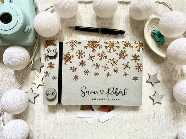 Silver guest book personalized with custom engraved names and wedding date and snowflakes