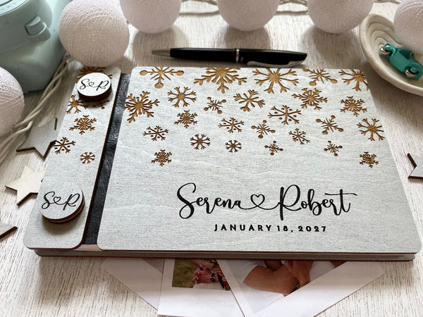 Silver guest book personalized with custom engraved names and wedding date and snowflakes