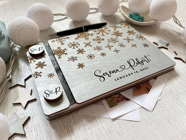Silver guest book personalized with custom engraved names and wedding date and snowflakes