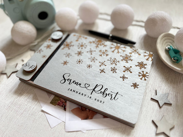 Silver guest book personalized with custom engraved names and wedding date and snowflakes