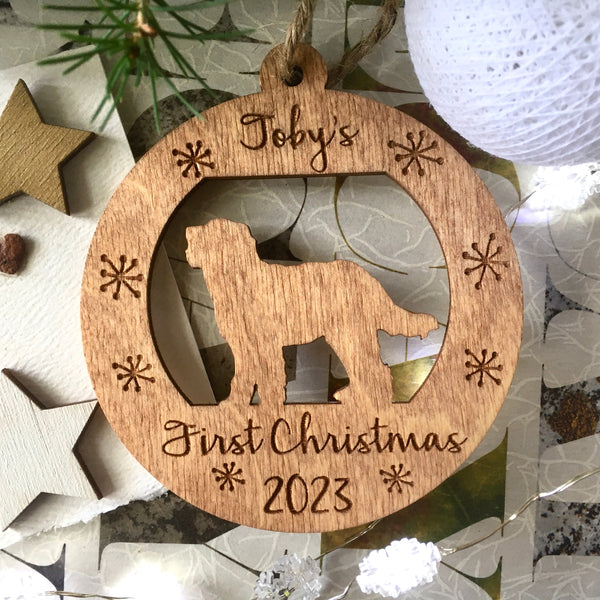personalized puppy's first Christmas ornament round with golden doodle silhouette on brown stain wood