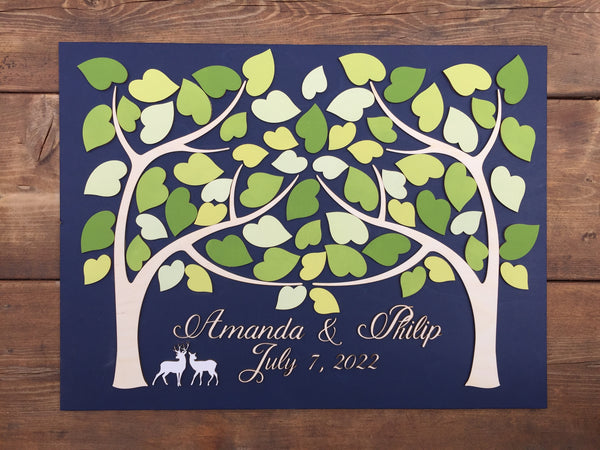 Personalized wedding guest book alternative with two trees that merge and a pair of deer with fresh green leaves for wedding sign in