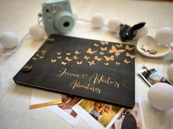 butterflies couple's adverture book made with wooden covers engraved with butterflies, the names of the couple and custom text