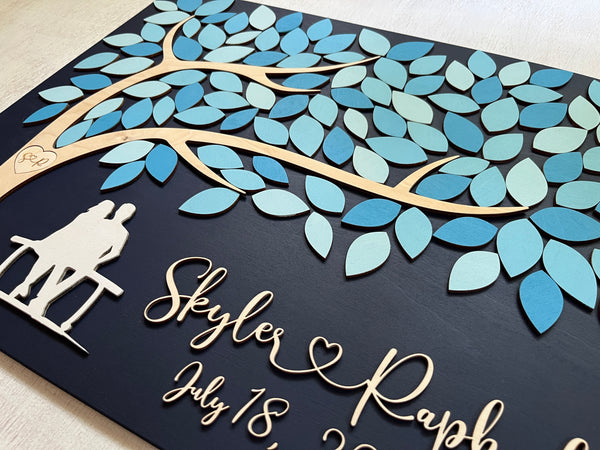 detail to show the couple silhouette under the tree of life guest book