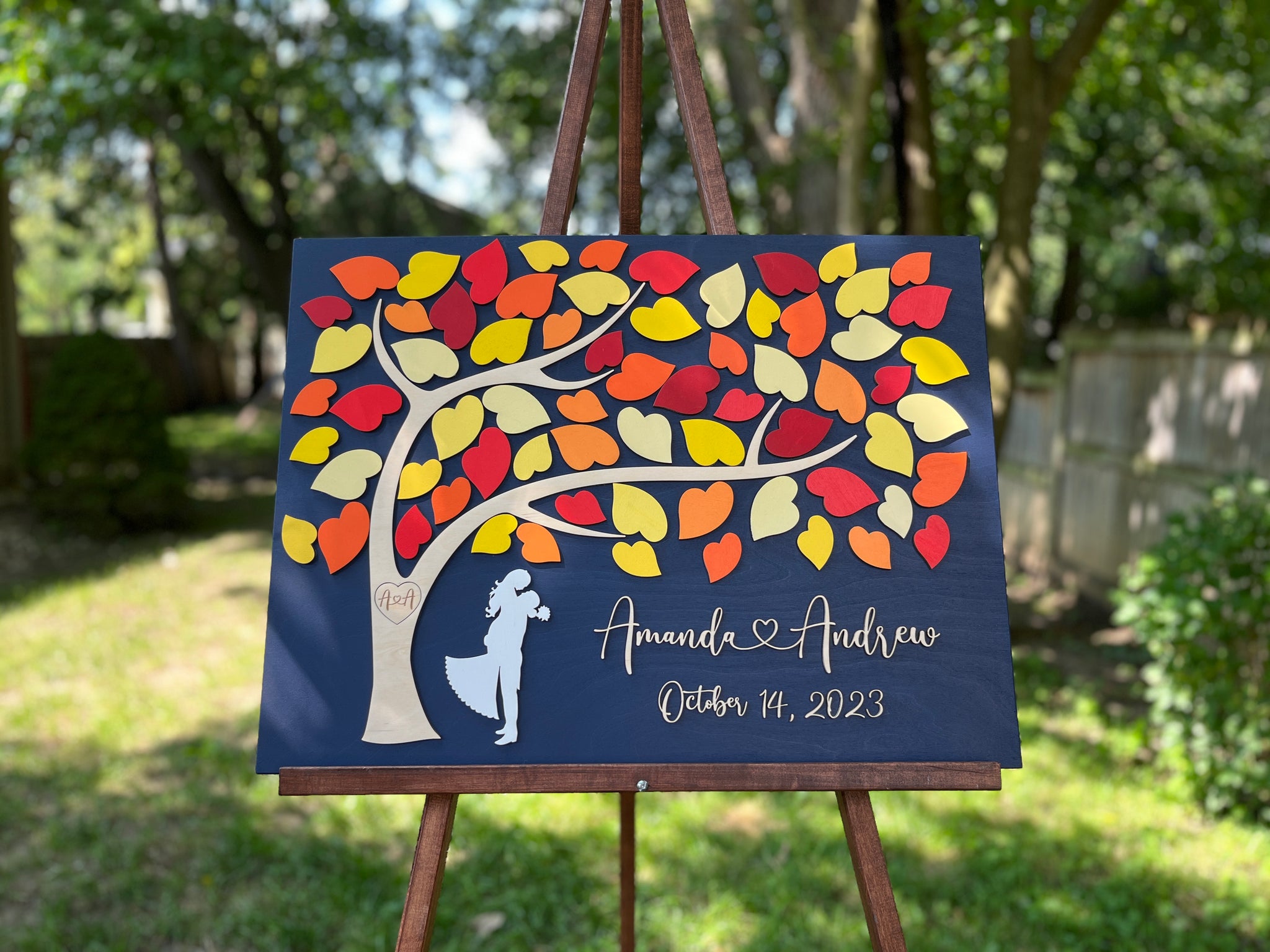 fall guest book alternative with personalized names and wedding date and a tree with fall coloured leaves to be signed by guests