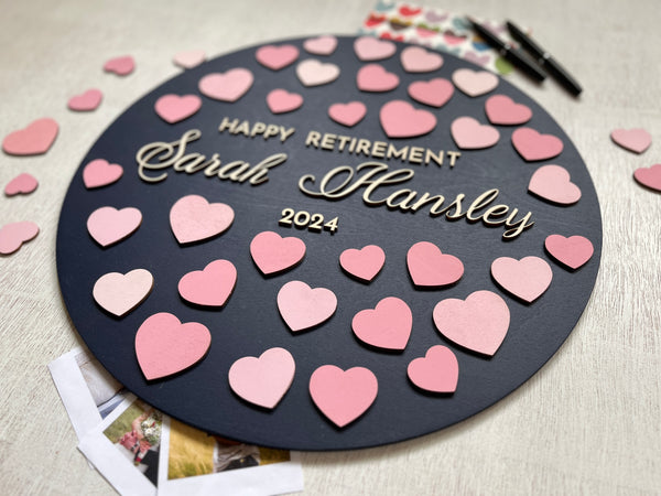 each co-worker signs a heart for the retiree