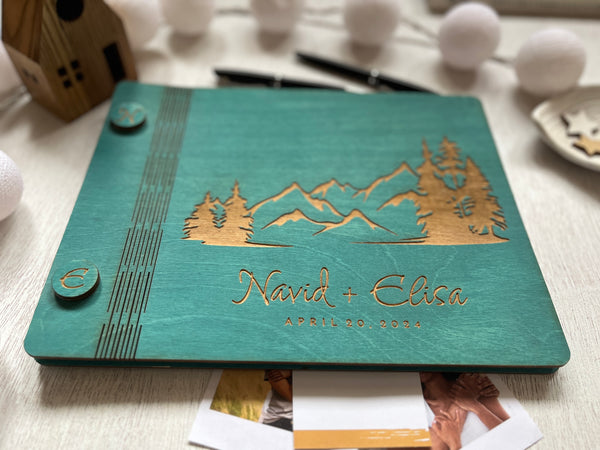 personalized engraved guest book made with wooden teal covers and mountain scenery