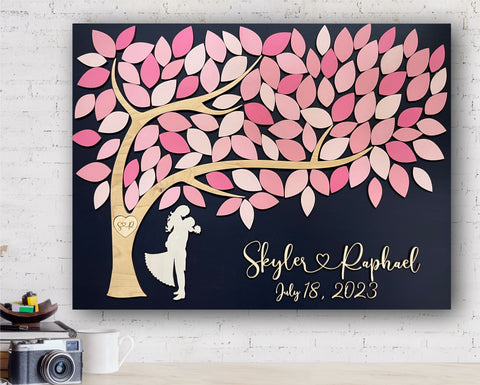 pink wedding guest book alternative made of wood and tree of life with embracing couple under the tree and leaves to sign