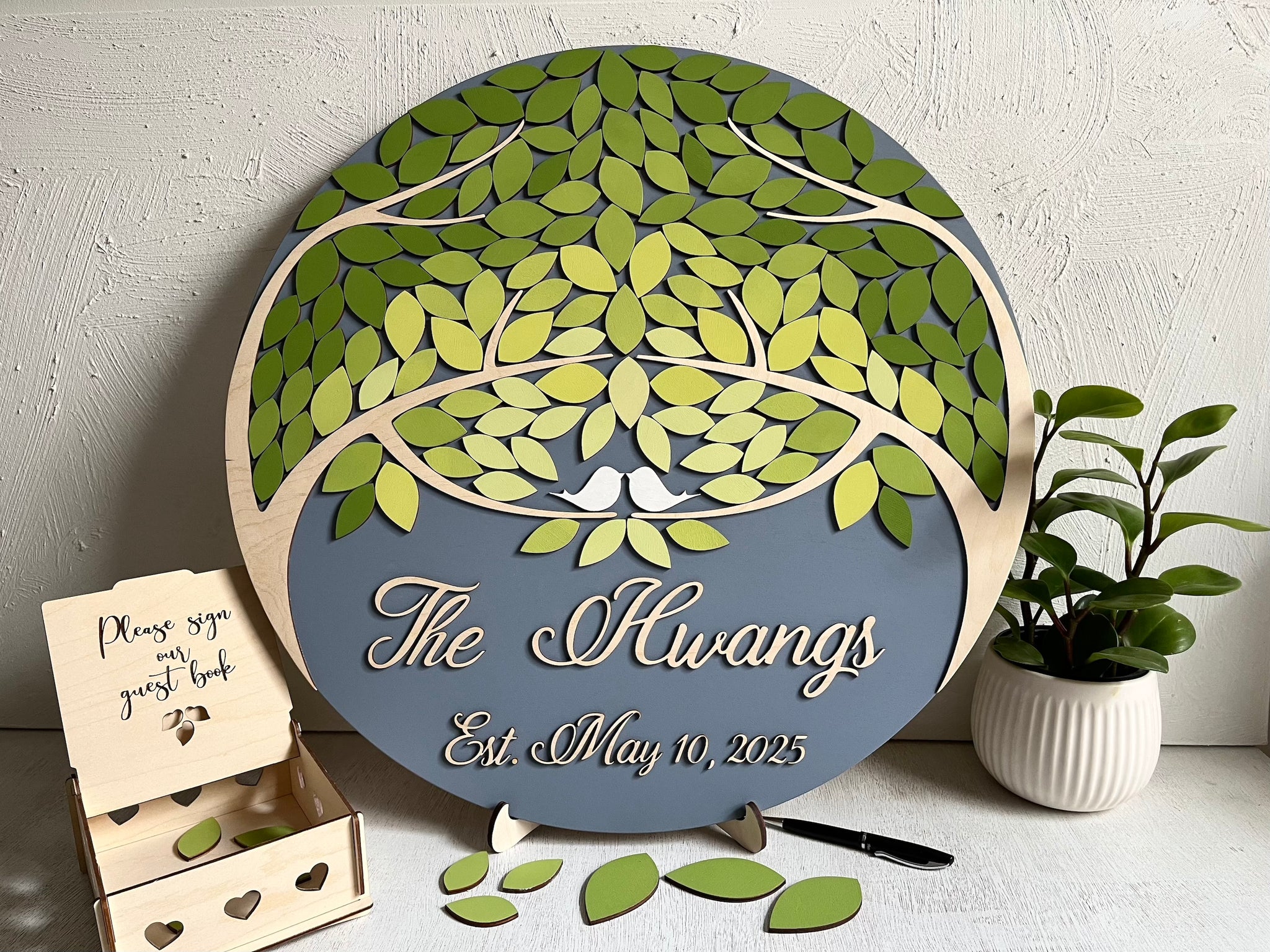 magnetic guest book set with green leaves and grey background personalized with last name and wedding date