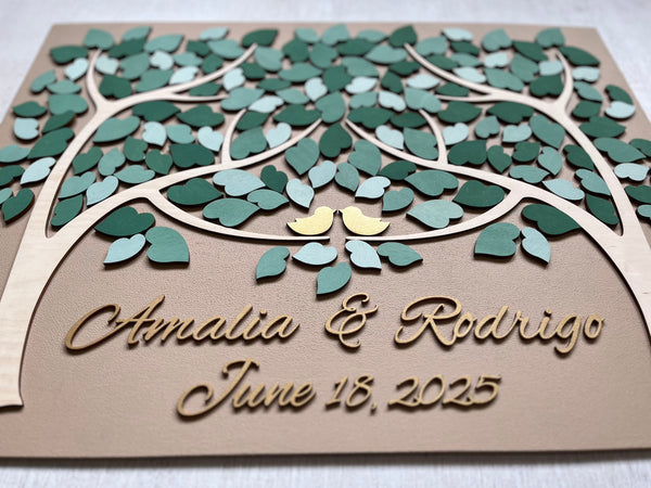 personalized guest book with tan background, two trees, a mix of green leaves, gold birds and golden personalized names and date