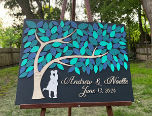 wedding guest book alternative with tree of life and leaves to sign with kissing couple under the tree