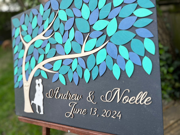 side detail of wood wedding guest book with leaves to sign