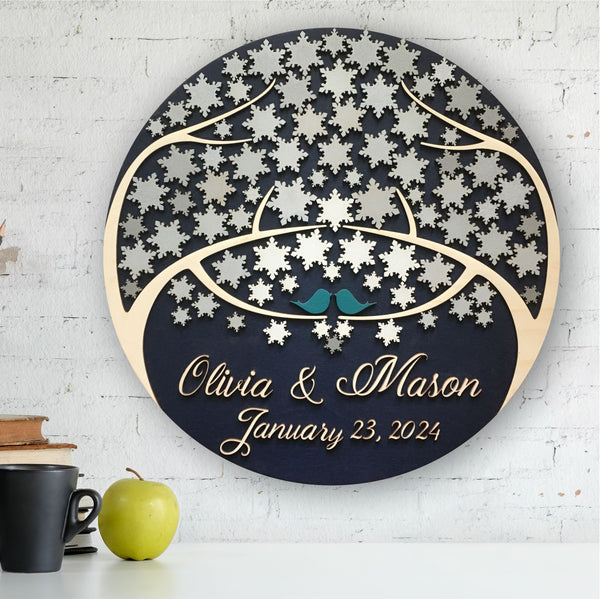 round guest book alternative with personalized names and date for wedding and snowflakes to sign shown  mounted on a wall