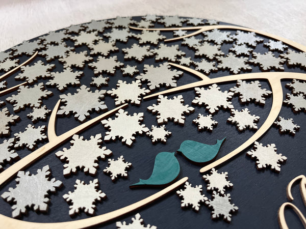 detail to show love birds on round guest book alternative with personalized names and date for wedding and snowflakes to sign