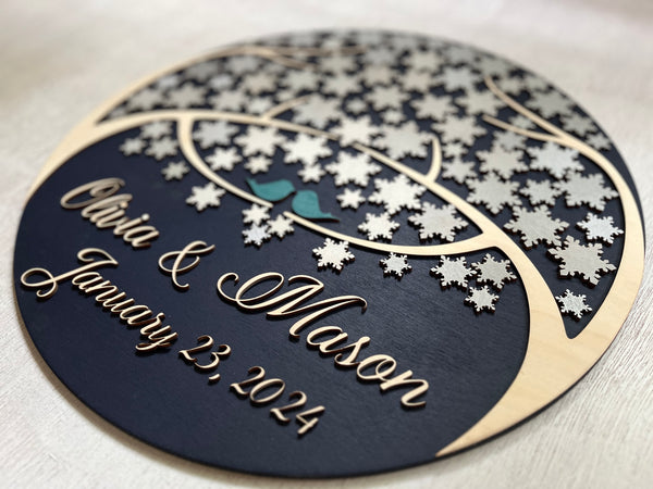 detail of round guest book alternative with personalized names and date for wedding and snowflakes to sign