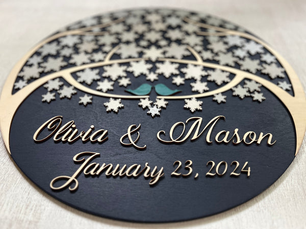 detail of personalized names round guest book alternative with personalized names and date for wedding and snowflakes to sign