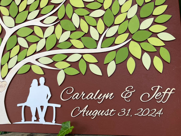 detail of spring wedding guest book alternative with tree of life and leaves for signatures
