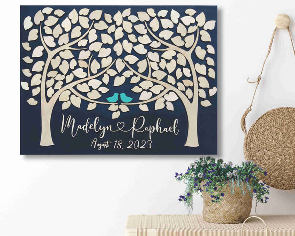 two trees wedding guest book shown on a wall in a home entryway
