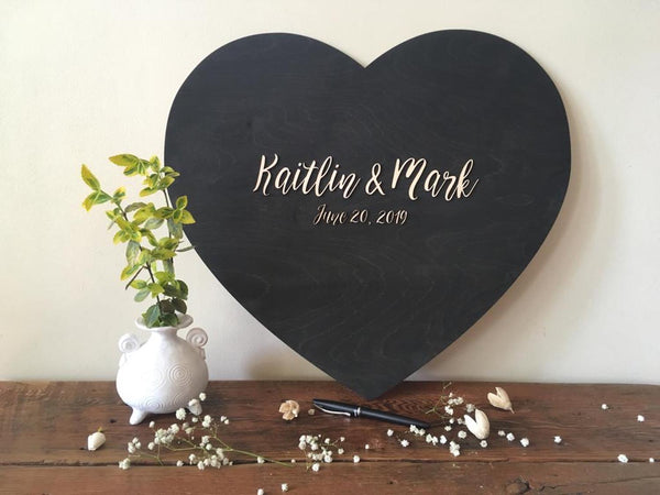 styled scene with black stain heart guestbook alternative