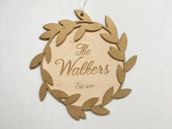 custom engraved family name sign with dainty leaf work 