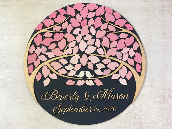 Round guest book alternative with two trees and leaves arranged in an ombre effect in pink shades, customizable names, date and colors 