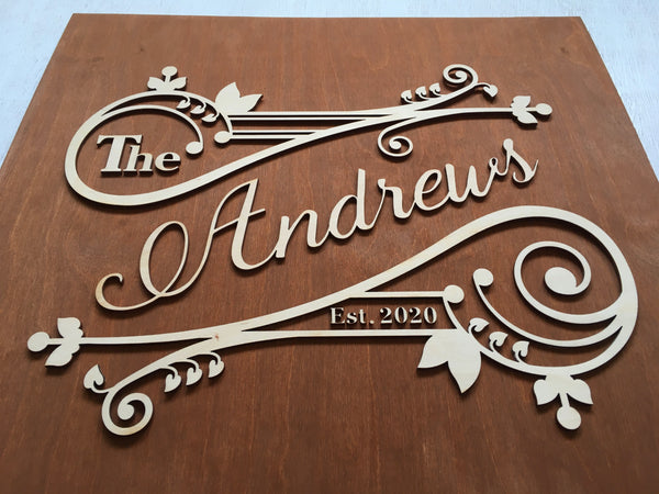 The example is made on a brown stained base and laser cut lettering and swirled motifs