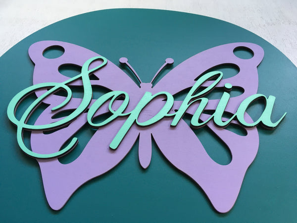The example shows the backgrouund in teal, the butterfly in lavender and the name in mint, but the colors can be further personalized