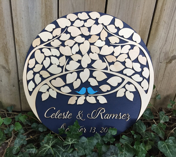 The guest book is made on a navy background and natural wooden colored leaves with beach blue birds