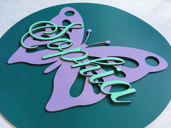The name is cutout from wood using laser technology and is made in a calligraphic font