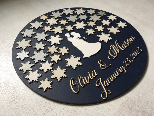 a guest book made with snowflakes for signing and customized with the names of the couple and wedding date