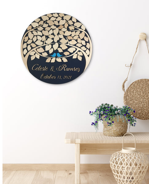 custom guest book with two trees on a round disc shown in a room decor