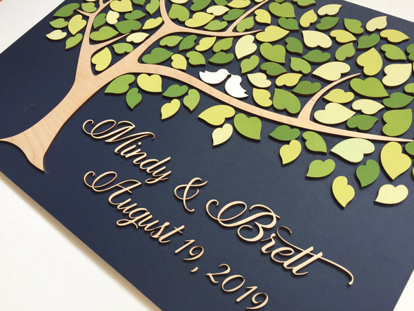 detail of guestbook made of wood and green leaves in a tree of life
